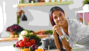 Young woman standing near desk in the kitchen