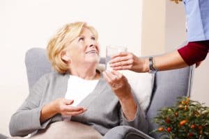 Home caregiver with old patient